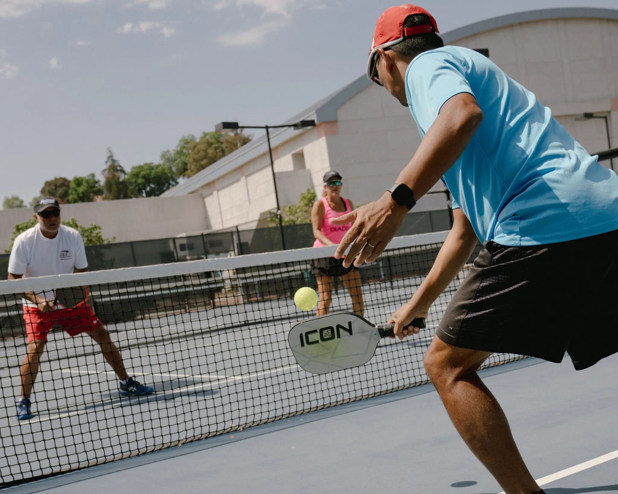 Person playing pickleball at the net